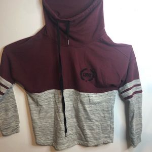 A burgundy and grey hoodless sweatshirt